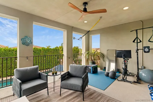 a kitchen with stainless steel appliances granite countertop a stove top oven a sink a dining table and chairs with wooden floor