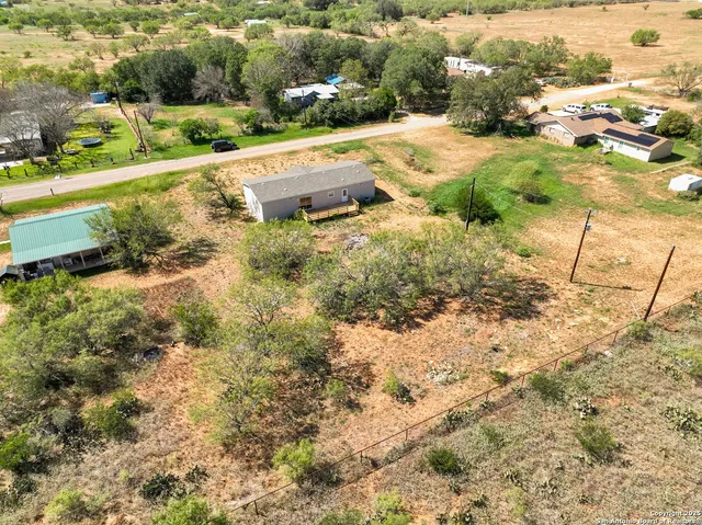 an aerial view of residential houses with outdoor space