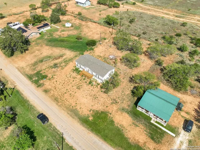 a view of a yard with wooden fence