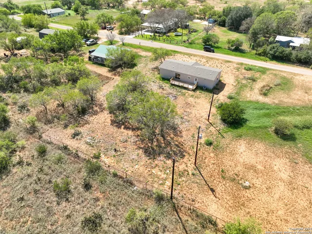 a backyard of a house with yard and outdoor seating