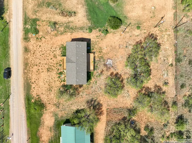 a backyard of a building with large trees