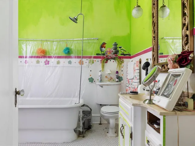 a bathroom with a sink a toilet and mirror