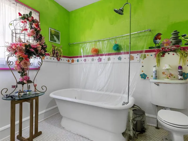 a bathroom with a toilet a sink and bathtub