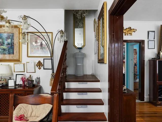 a view of entryway and hall with wooden floor