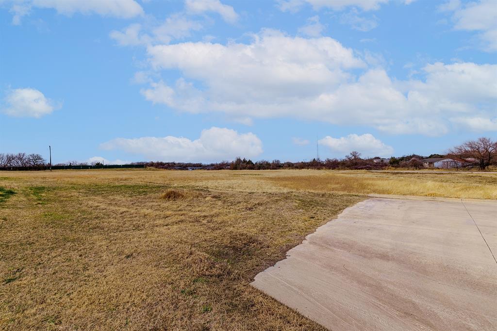 700 South Deer Park Road Decatur, TX 76234 - Photo 17 of 40 View of grassy yard featuring a view of countryside