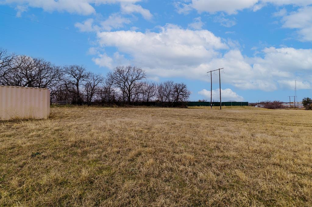 700 South Deer Park Road Decatur, TX 76234 - Photo 18 of 40 View of grassy yard featuring a view of rural / pastoral area