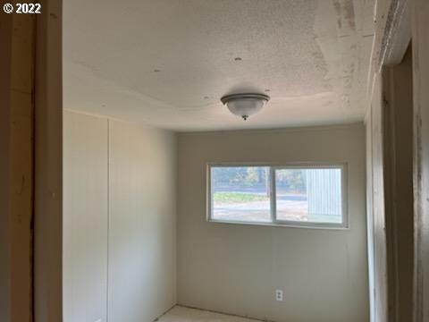 37635 Row River Road Dorena, OR 97434 - Photo 2 of 8 a view of an empty room with a window