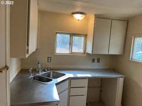 37635 Row River Road Dorena, OR 97434 - Photo 4 of 8 a kitchen with a sink cabinets and window