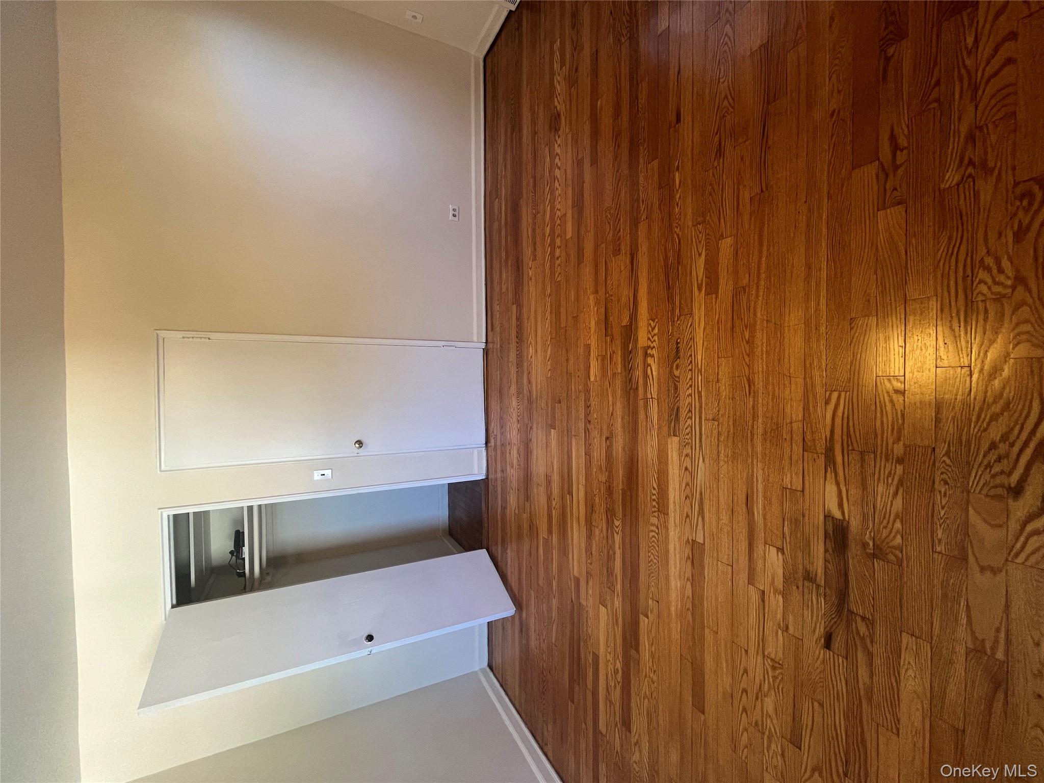 325 East 201st Street, Unit 4D Bronx, NY 10458 - Photo 11 of 22 Unfurnished bedroom with dark wood-style floors and a closet