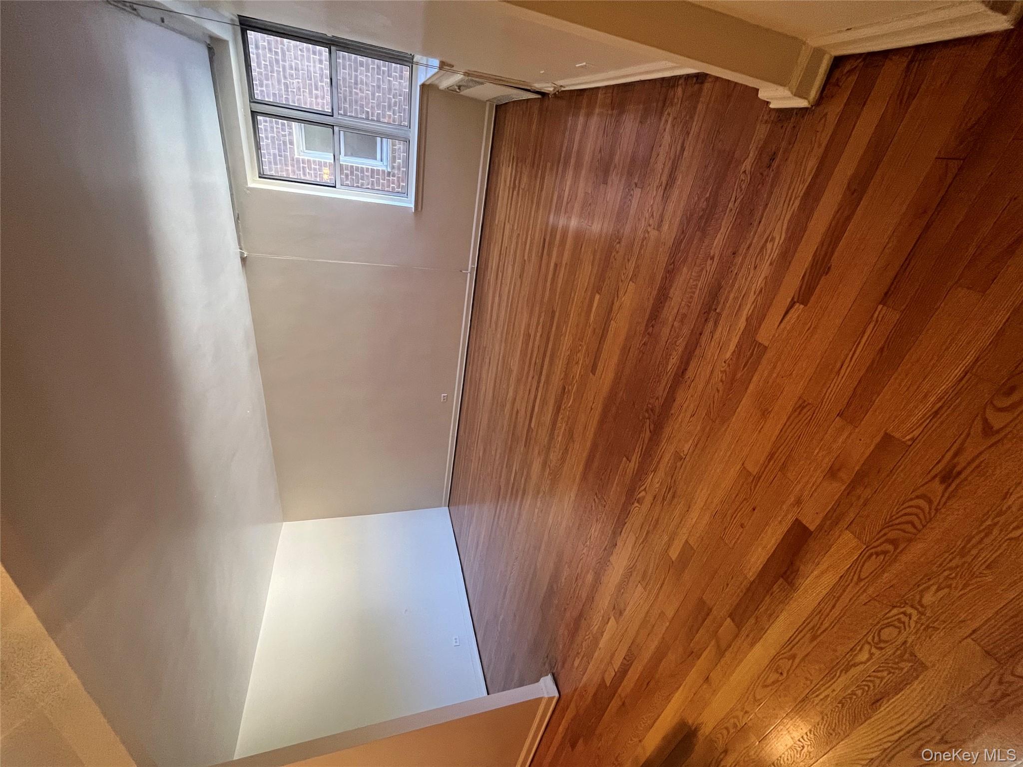325 East 201st Street, Unit 4D Bronx, NY 10458 - Photo 14 of 22 Unfurnished room with dark wood-style flooring and baseboards