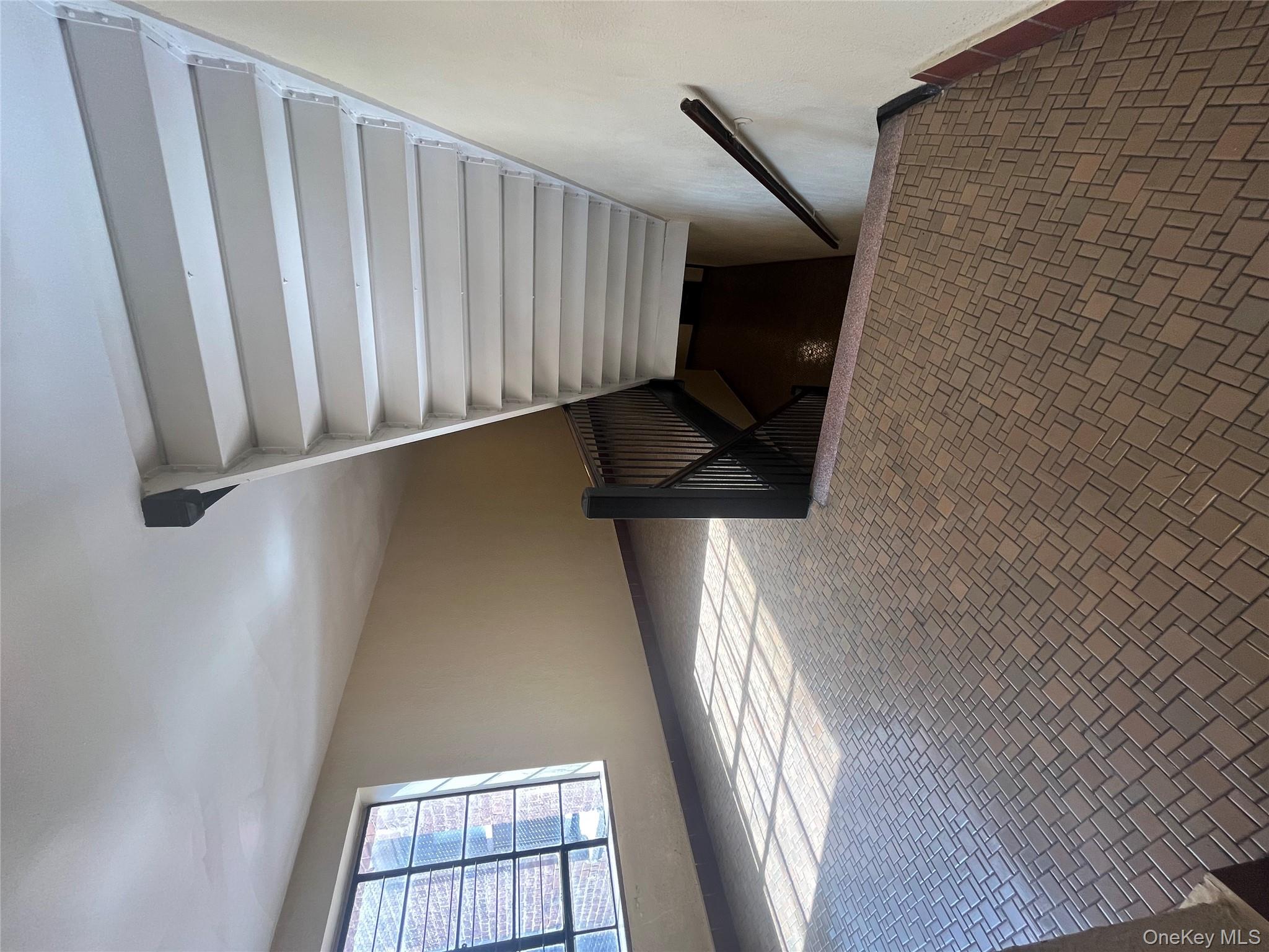 325 East 201st Street, Unit 4D Bronx, NY 10458 - Photo 21 of 22 Stairway featuring baseboards