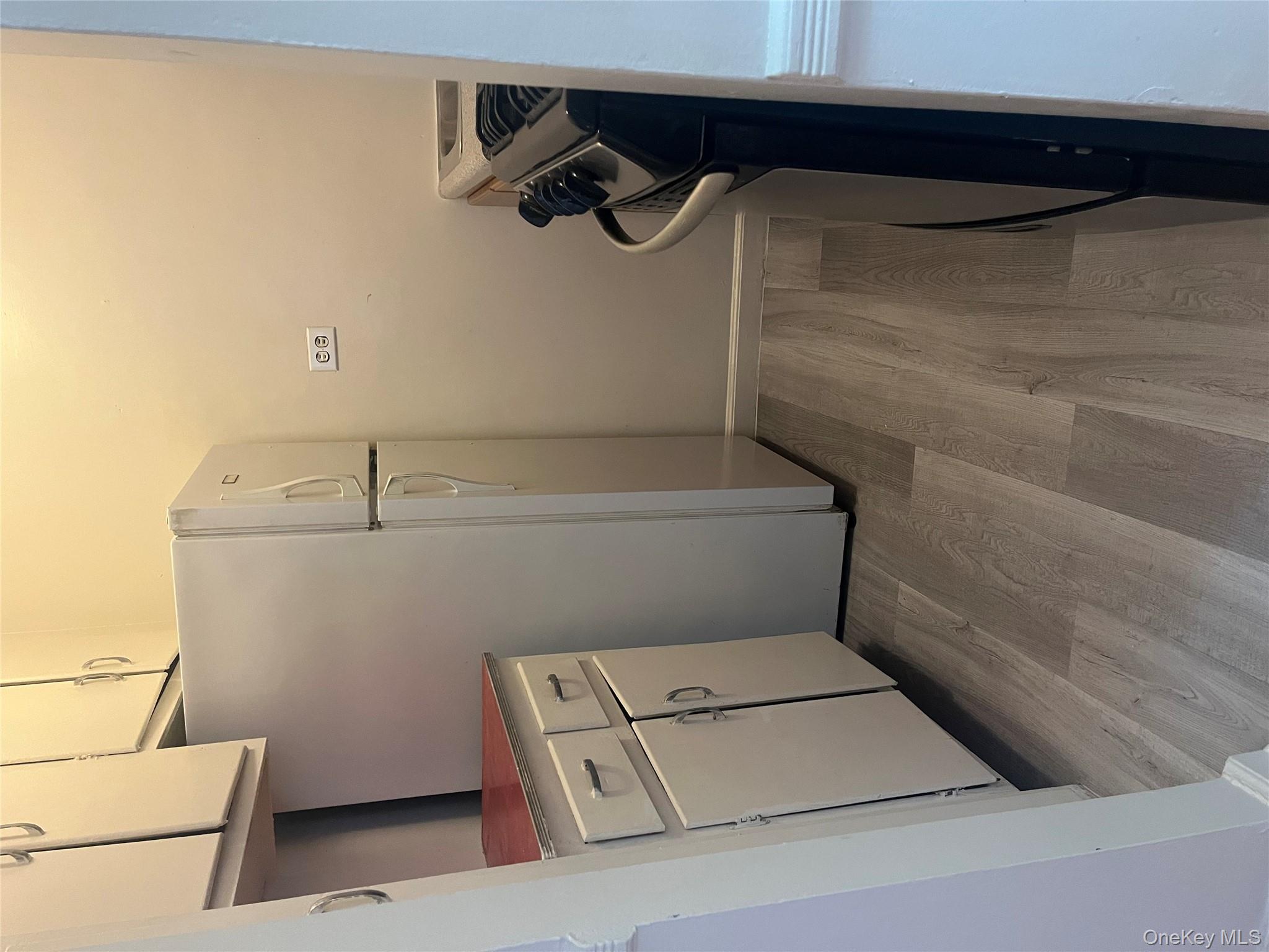 325 East 201st Street, Unit 4D Bronx, NY 10458 - Photo 5 of 22 Kitchen featuring light wood-type flooring, stove, white cabinetry, and freestanding refrigerator