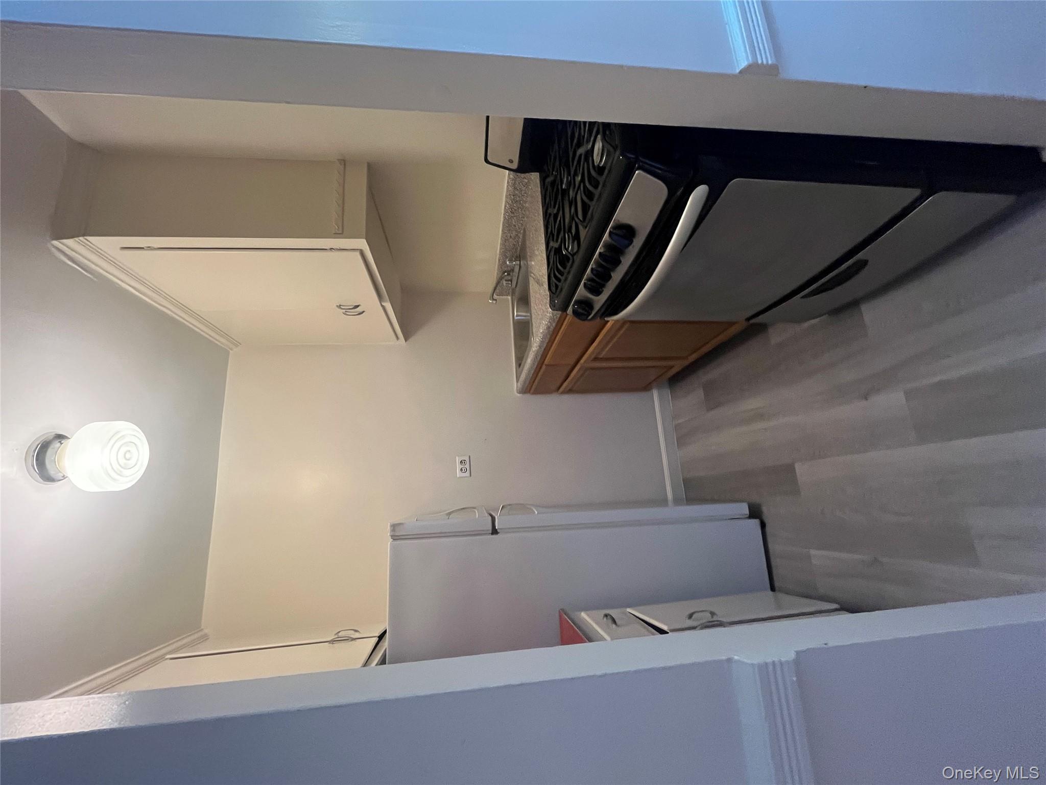 325 East 201st Street, Unit 4D Bronx, NY 10458 - Photo 6 of 22 Kitchen featuring range, light wood-style flooring, and refrigerator