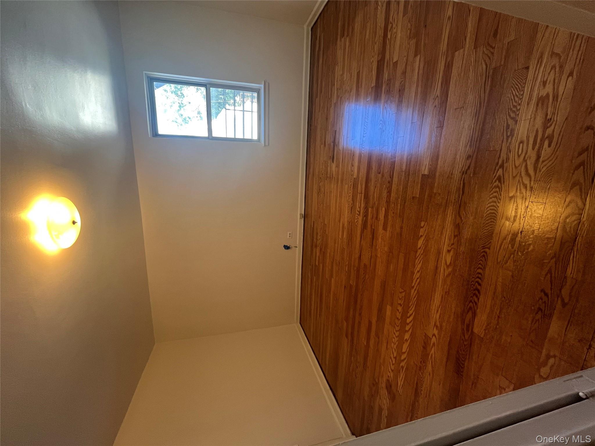 325 East 201st Street, Unit 4D Bronx, NY 10458 - Photo 8 of 22 Additional living space with baseboards and dark wood-style flooring