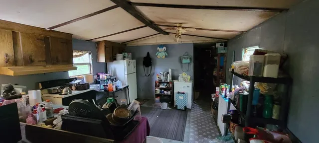 a living room filled with furniture and a window