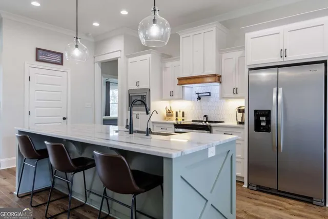 a kitchen with cabinets a counter space stainless steel appliances and cabinets