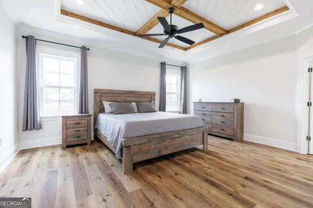 a bedroom with a large bed and a window