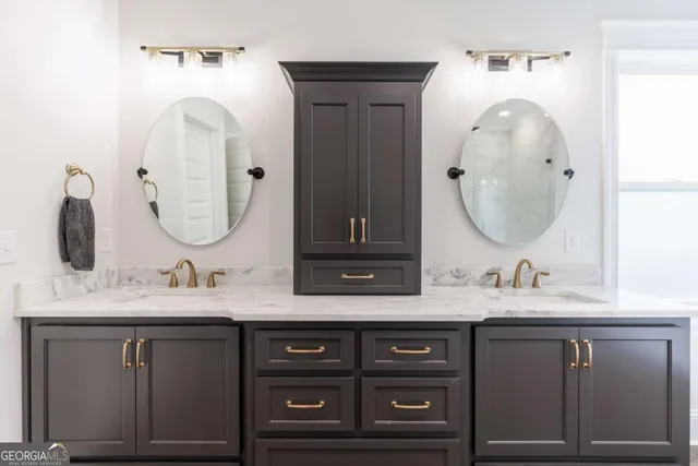 a bathroom with a double vanity sink and a mirror