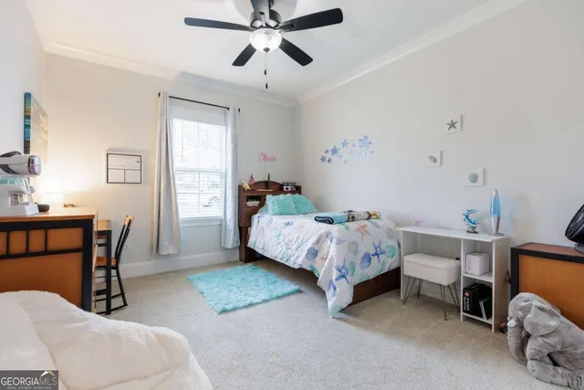 a bedroom with a bed a chandelier and a window