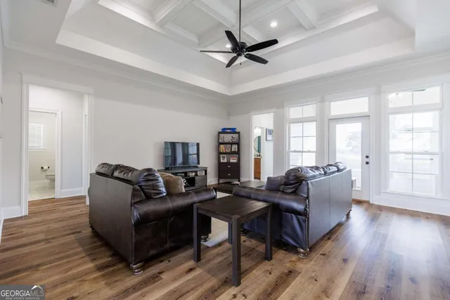 a living room with furniture and a wooden floor