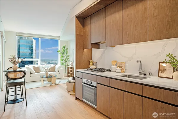 a large white kitchen with a lot of white cabinets and a dishwasher