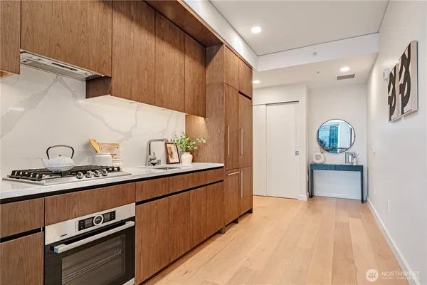 a kitchen with stainless steel appliances a stove a sink and a refrigerator