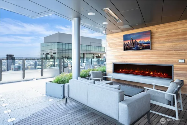 a living room with furniture a flat screen tv and a fireplace