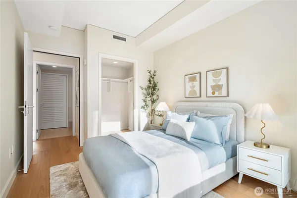 a bedroom with a bed and a lamp