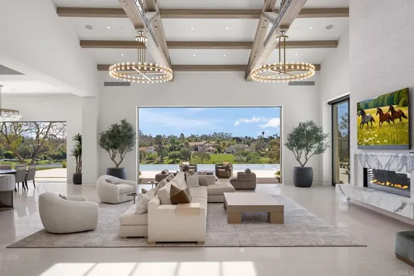 a living room with furniture and a floor to ceiling window