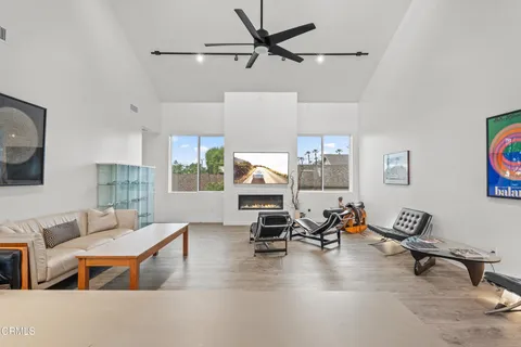 a living room with furniture gym equipment and a view of kitchen