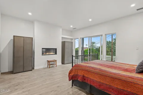 a living room with stainless steel appliances kitchen island granite countertop furniture and a wooden floor