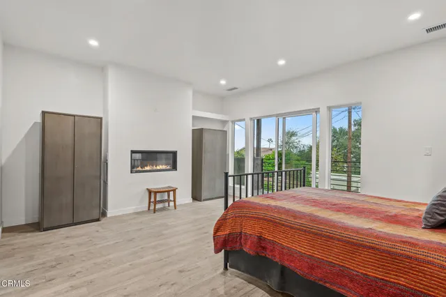 a living room with stainless steel appliances kitchen island granite countertop furniture and a wooden floor