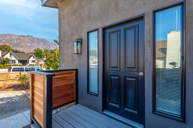 a view of a floor to ceiling window and potted plants