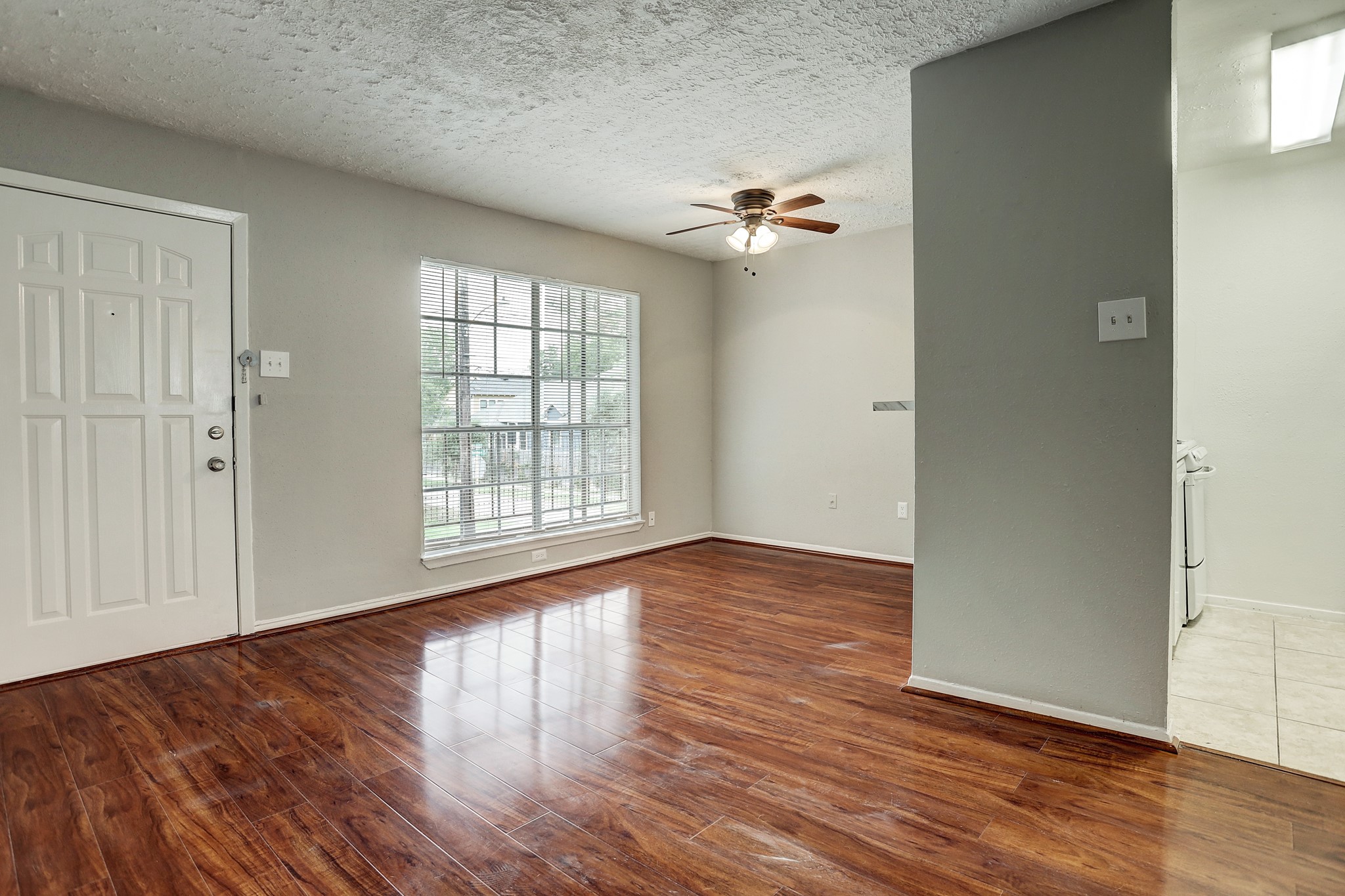 513 Ridge Street, Unit 21 Houston, TX 77009 - Photo 1 of 9 a view of empty room with wooden floor and fan