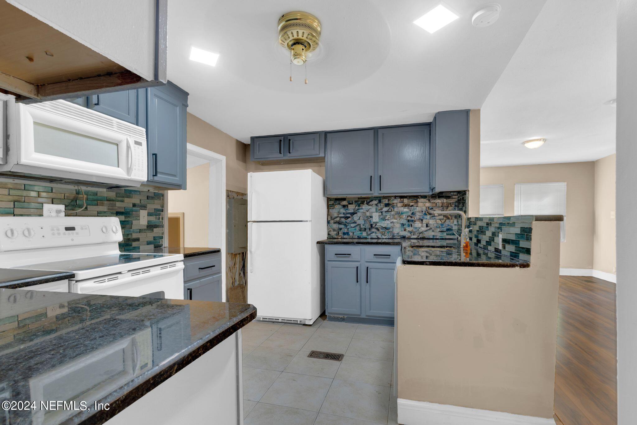 10357 Anson Road Jacksonville, FL 32246 - Photo 18 of 27 a kitchen with a refrigerator and a sink