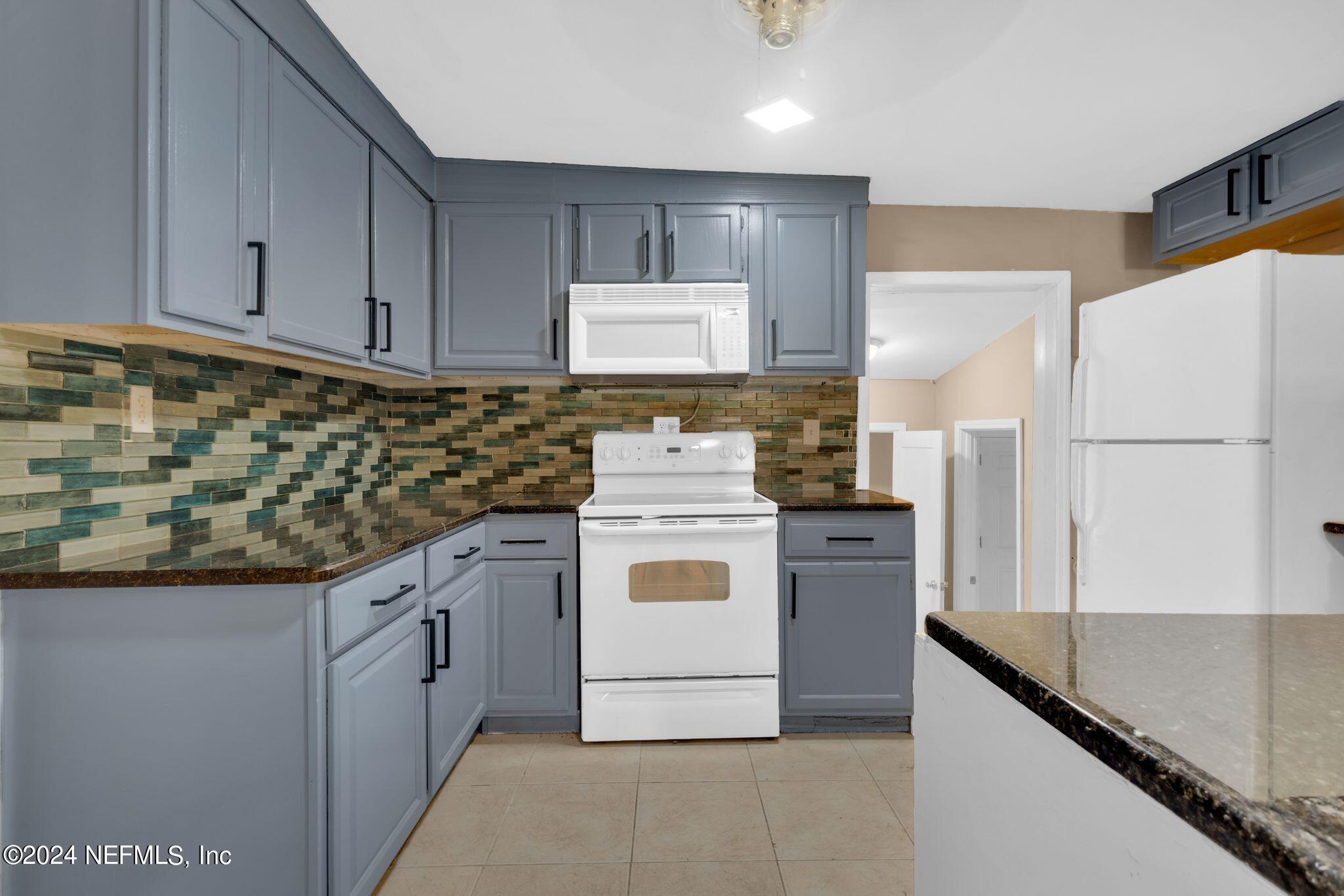 10357 Anson Road Jacksonville, FL 32246 - Photo 19 of 27 a kitchen with stainless steel appliances granite countertop a stove a refrigerator and a sink