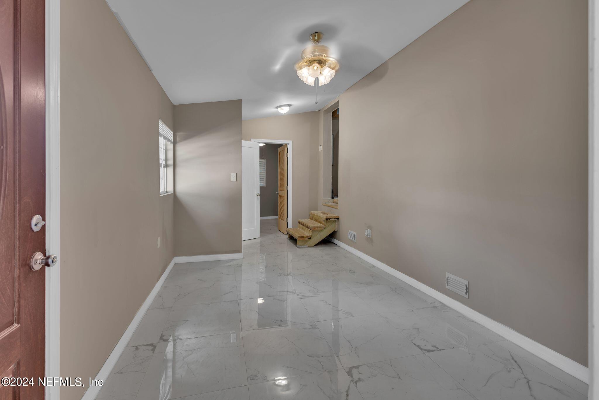 10357 Anson Road Jacksonville, FL 32246 - Photo 20 of 27 a view of empty room with wooden floor