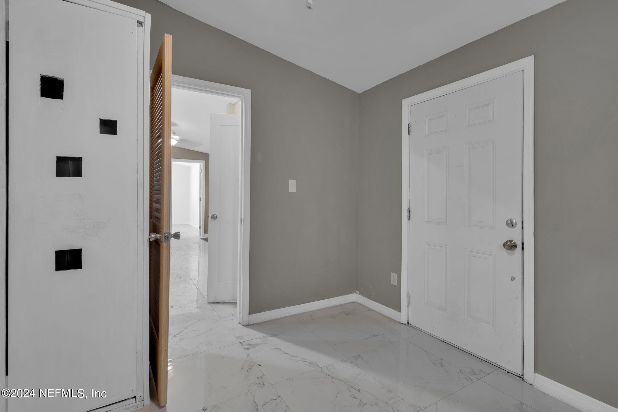 10357 Anson Road Jacksonville, FL 32246 - Photo 22 of 27 a view of a hallway with white doors