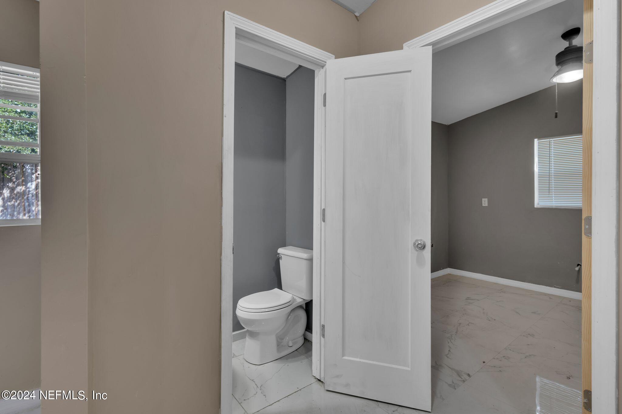 10357 Anson Road Jacksonville, FL 32246 - Photo 23 of 27 a bathroom with a toilet