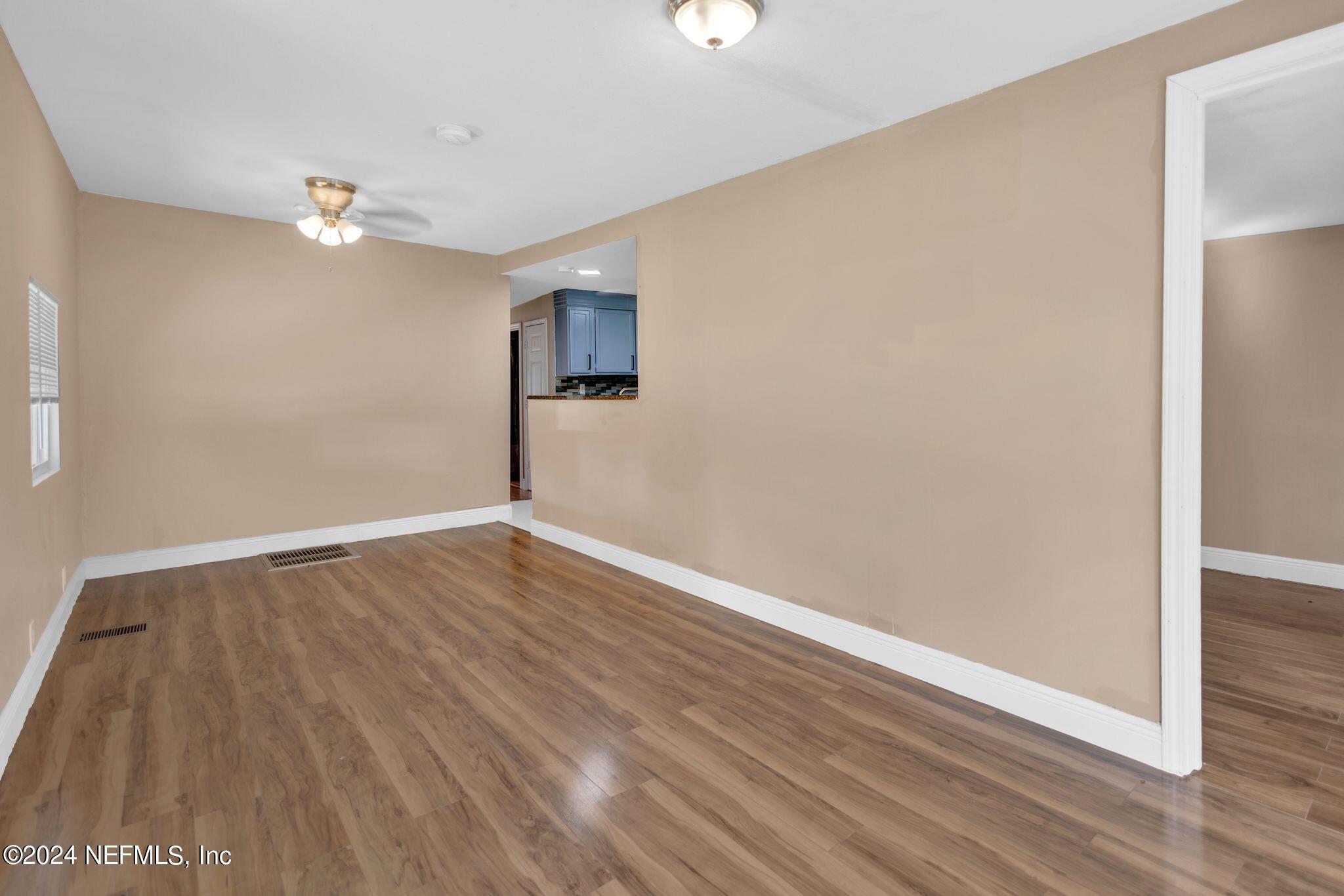 10357 Anson Road Jacksonville, FL 32246 - Photo 5 of 27 a view of empty room with wooden floor