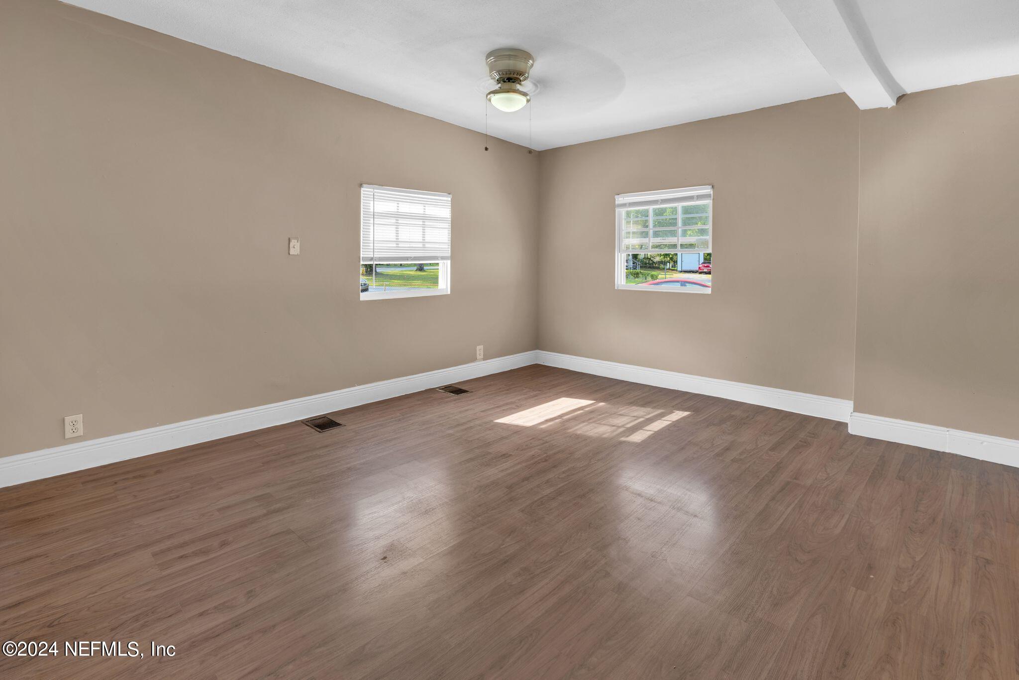 10357 Anson Road Jacksonville, FL 32246 - Photo 7 of 27 wooden floor in an empty room with a window
