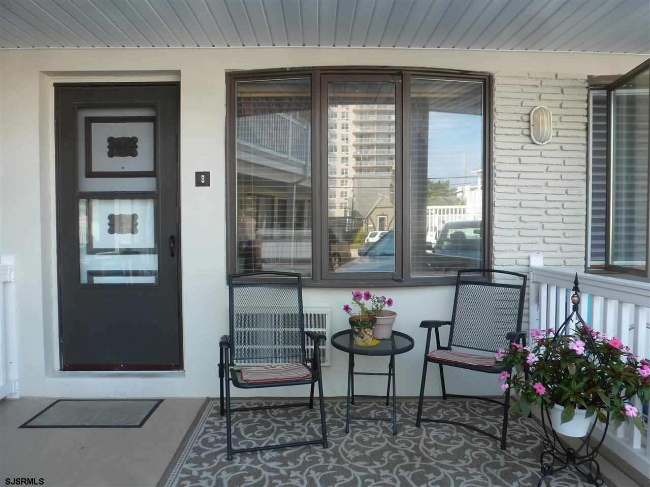 a table and chairs in front of a house