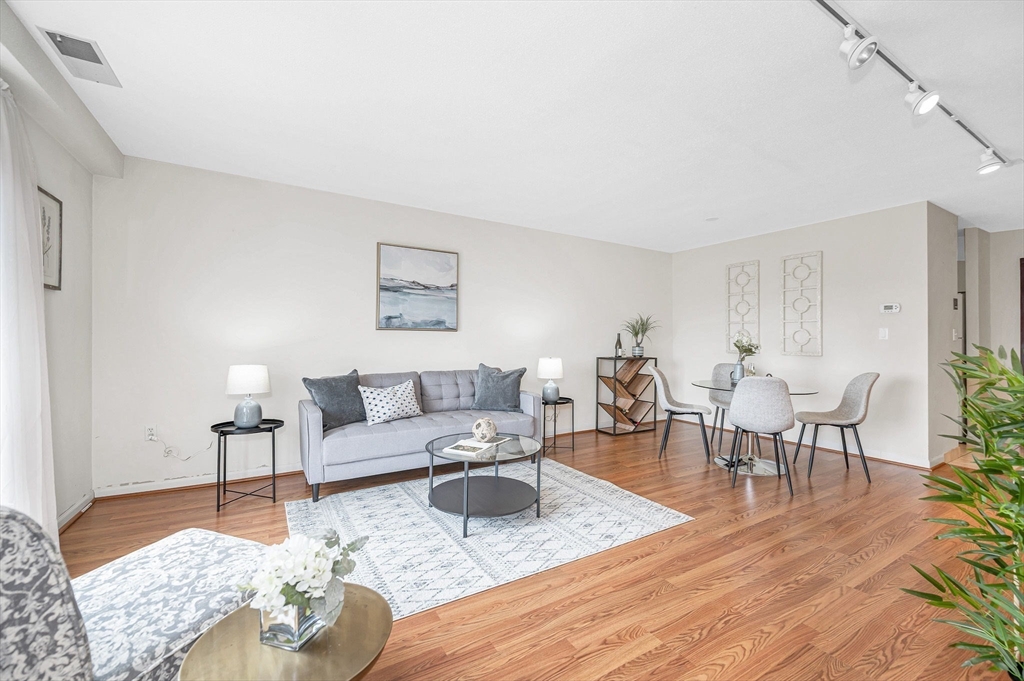 4 Summit Drive, Unit 413 Reading, MA 01867 - Photo 1 of 20 a living room with furniture and wooden floor