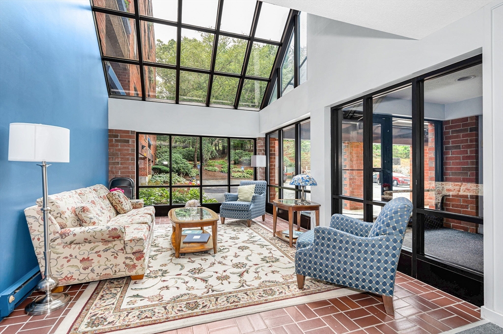 4 Summit Drive, Unit 413 Reading, MA 01867 - Photo 20 of 20 a living room with furniture fireplace and a large window