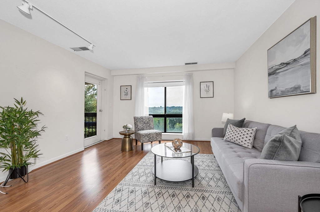 4 Summit Drive, Unit 413 Reading, MA 01867 - Photo 3 of 20 a living room with furniture and wooden floor