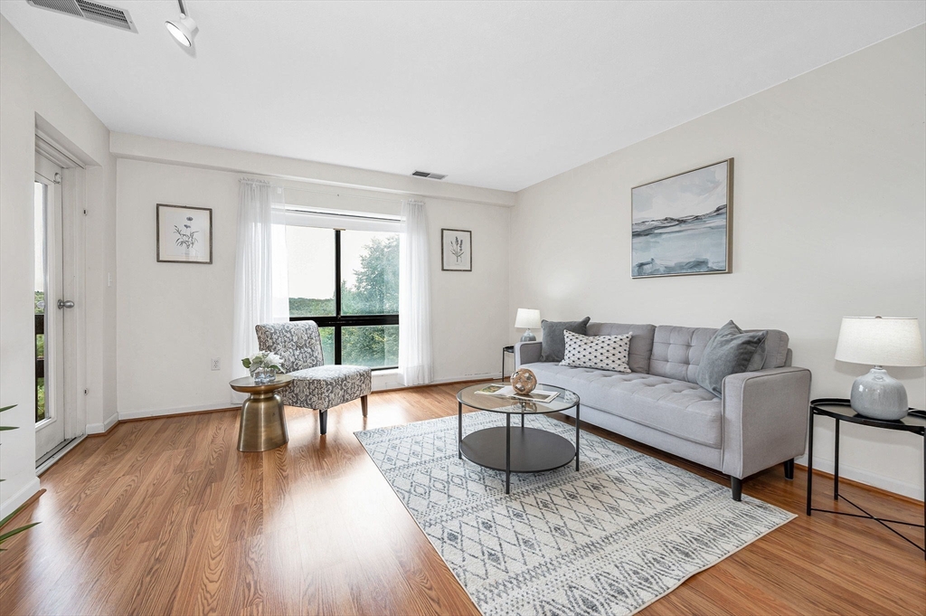 4 Summit Drive, Unit 413 Reading, MA 01867 - Photo 4 of 20 a living room with furniture and a large window