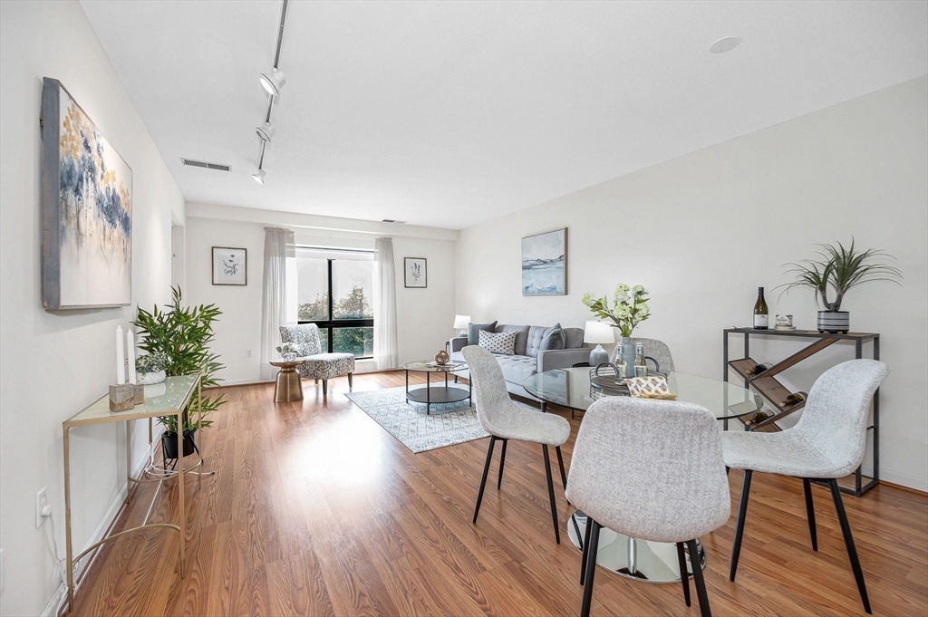 4 Summit Drive, Unit 413 Reading, MA 01867 - Photo 6 of 20 a living room with furniture dining table and wooden floor