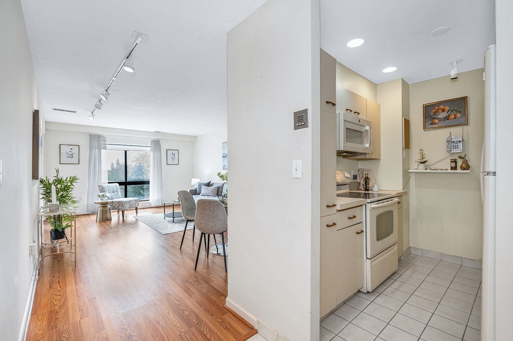 4 Summit Drive, Unit 413 Reading, MA 01867 - Photo 9 of 20 a kitchen with a refrigerator and a stove top oven