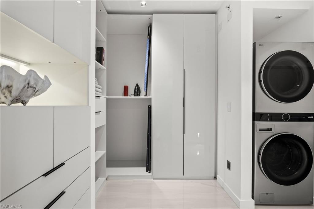 1100 Pine Ridge Road, Unit B103 Naples, FL 34108 - Photo 25 of 38 a view of a hallway with washer and dryer