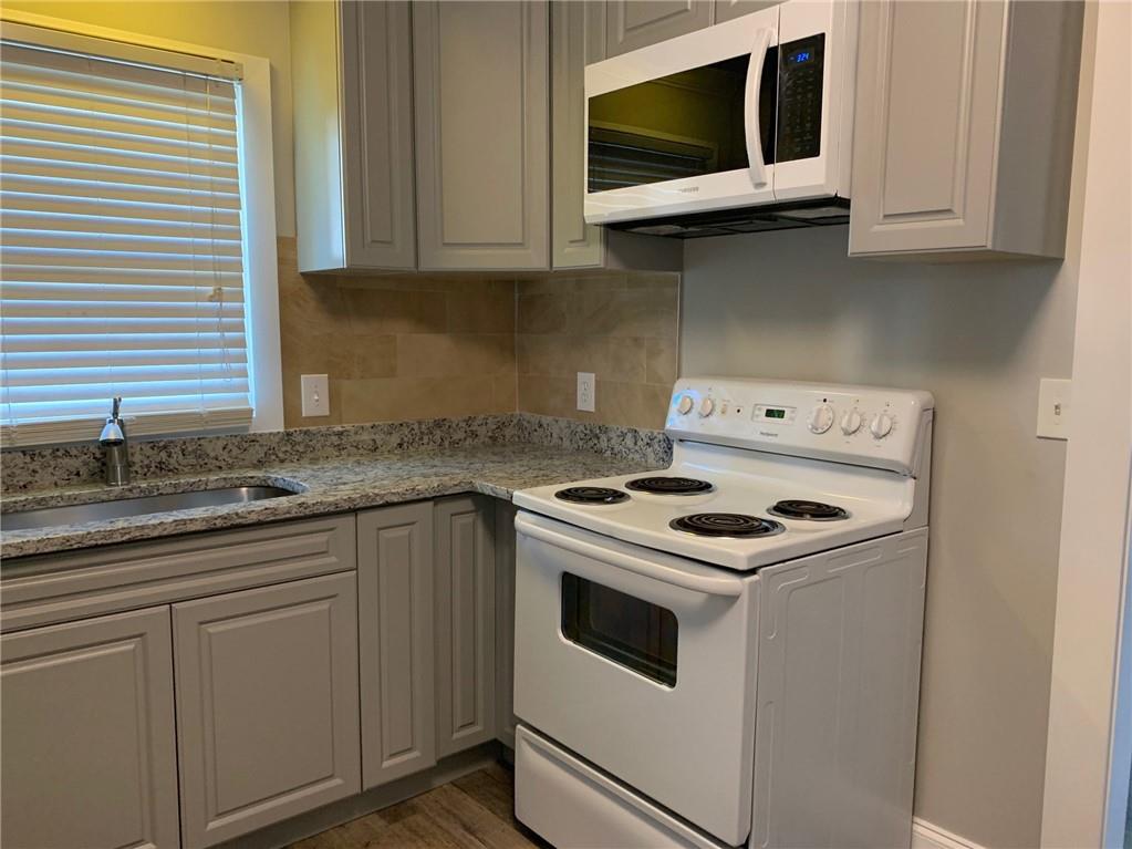 1261 Concord Road Southeast Smyrna, GA 30080 - Photo 20 of 50 a kitchen with granite countertop white cabinets and white appliances